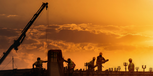 Photo of Construction Site with a Crane at Sunset