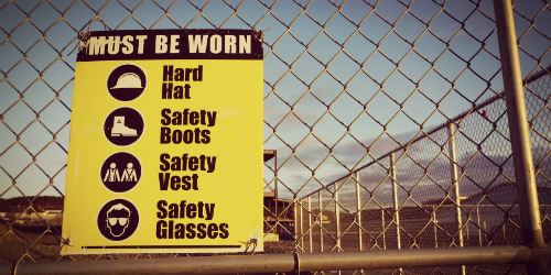Personal Protective Sign on Worksite Fence