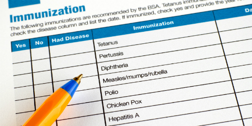 Vacinations checklist with orange pen