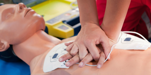 Photo of Person Delivering CPR Chest Compressions
