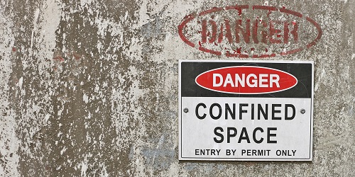 Confined Space Warning Sign on a Concrete Wall