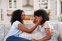 mother talking with unhappy teenage daughter