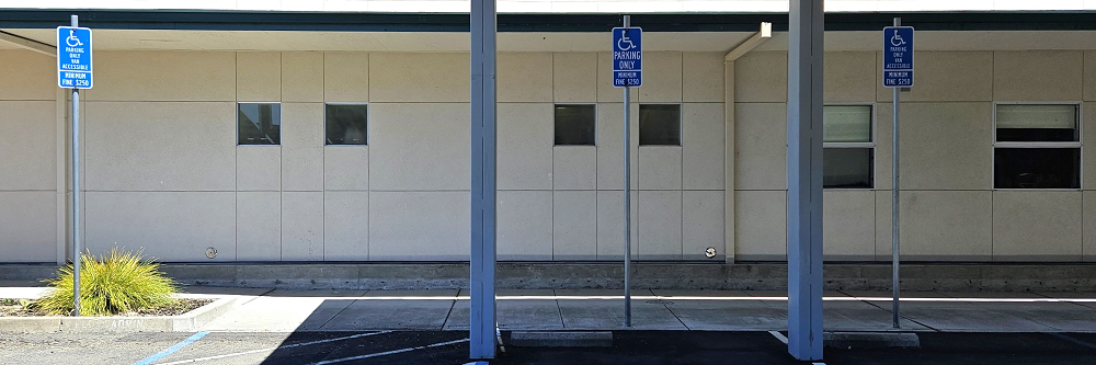 A picture of the three handicapped parking spaces side by side. The leftmost space is a van-accessible parking spot.