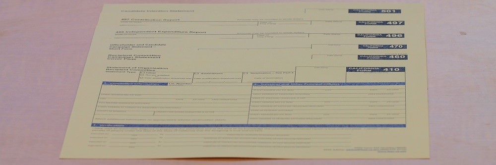 A stack of California campaign finance forms. The top one is blank and in big numbers says "410."