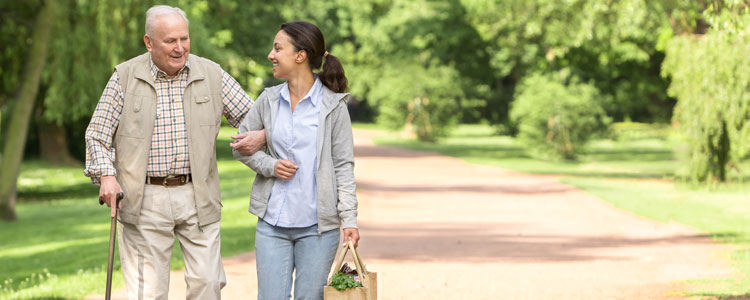 Client walks with caregiver outside
