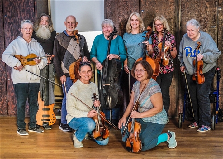 Group of older adult musicians posing with instruements