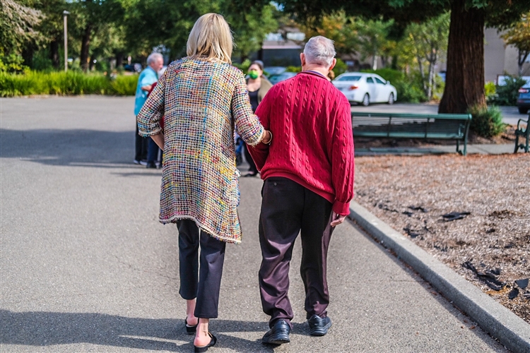 older couple walking with backs to the camera