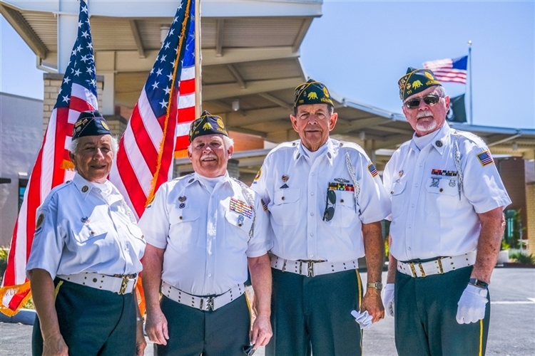 Four Veterans Stand in uniform outside the new VA building in Santa Rosa