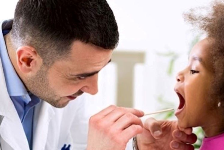 Child getting a checkup by Doctor